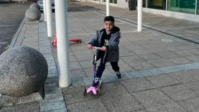 Sepehr with the scooter that a local family had donated