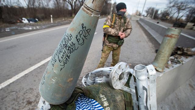 The remains of a cluster bomb rocket and other ordnance is collected as Ukraine Army troops dig in at frontline trench positions to continue repelling Russian attacks, east of the strategic port city of Mykolaiv, Ukraine, on March 10, 2022