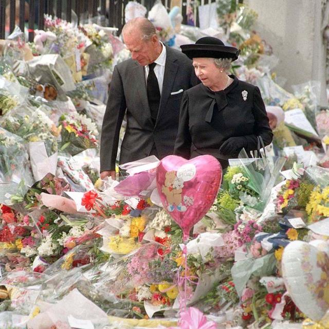 A rainha e o duque de Edimburgo olhando os tributos florais a Diana, princesa de Gales, no Palácio de Buckingham