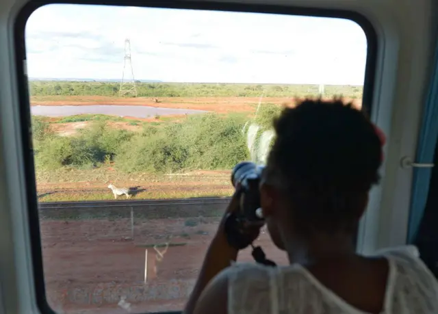 It takes four-and-a-half hours to get from Mombasa to Nairobi, compared to nine hours by bus or 12 hours on the previous railway. The railway passes through some of Kenya's famed national parks, where this woman photographed a zebra.