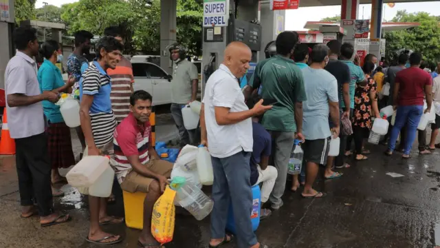 Sri Lankans queue up to obtain kerosene oil at a fuel station in Colombo, Sri Lanka, 12 May 2022. With the island nation experiencing a severe shortage of foreign exchange, imports of essential items were hit badly thus creating shortages in fuel, LP gas, food items etc. The shortage of fuel also caused forced power cuts island-wide.