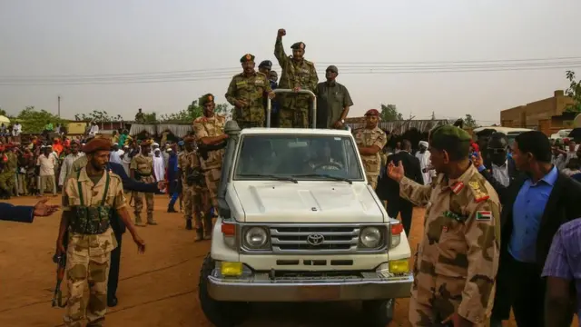 General Abdel Fattah al-Burhan, the head of Sudan's ruling military council, greeting supporters in Omdurman on 29 June