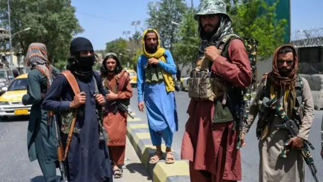 Taliban fighters are seen on the back of a vehicle in Kabul, Afghanistan, 16 August 2021