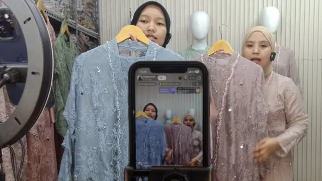 Traders live-stream on an e-commerce platform in Jakarta.