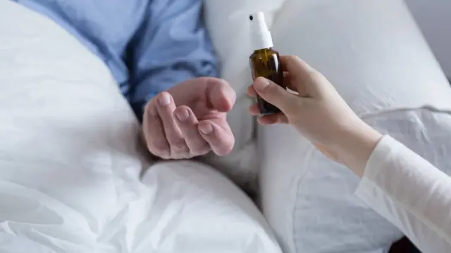 Person giving patient medication