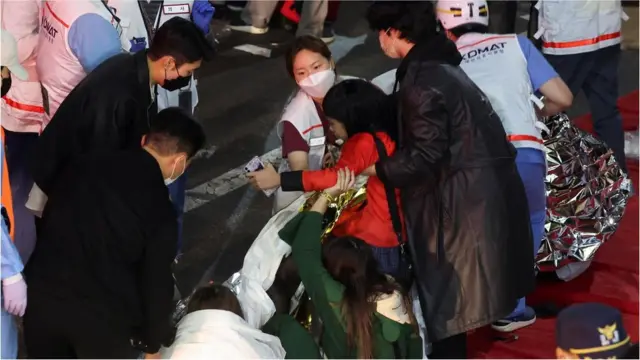 eople receive medical help from rescue team members at the scene where dozens of people were injured in a stampede during a Halloween festival in Seoul, South Korea, October 29, 2022