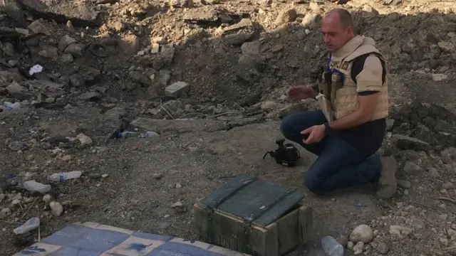 James Bevan junto a una caja de municiones.