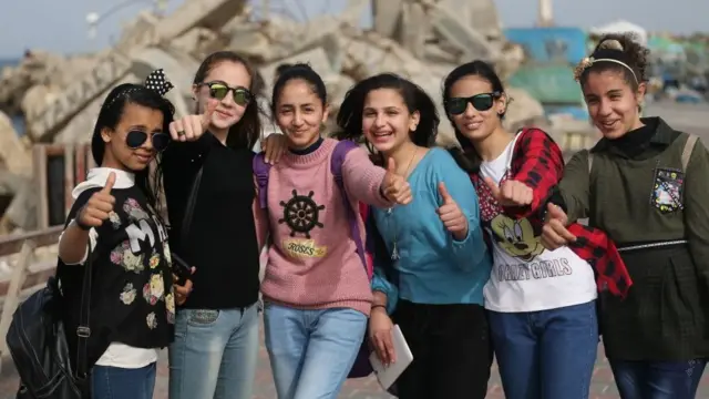 Palestinian school girls pose for a group picture during a school trip in Gaza City on March 8, 2018 to mark Women's Day