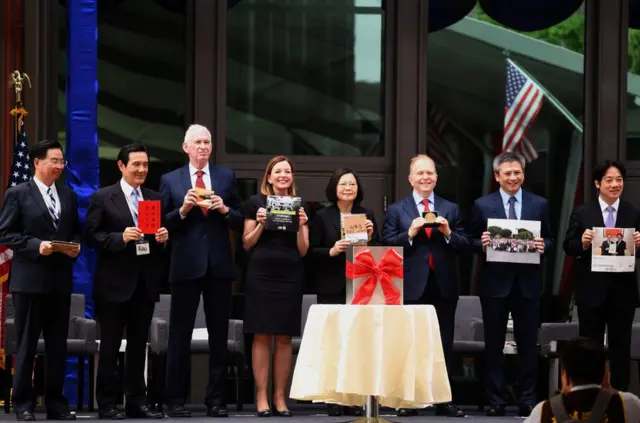 Taiwan"s Foreign Minister Joseph Wu, former President Ma Ying-jeou, chairman of the American Insitute in Taiwan (AIT) James Moriarty, US assistant Secretary of State for Education and Culture Affairs Marie Royce, Taiwan"s President Tsai Ing-wen, Overseas Buildings Office Principal Deputy Director Ambassador William Moser and AIT Director Kin Moy display their paraphernalia before placing them in a time capsule during the American Institute in Taiwan (AIT) new office complex dedication ceremony in Taipei on June 12, 2018. Washington on June 12 unveiled a multi-million-dollar new complex for its de facto embassy in Taiwan in what is hailed as a "milestone" in relations, a declaration likely to rile China. / AFP PHOTO / SAM YEHSAM YEH/AFP/Getty Images