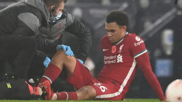 Liverpool defender Trent Alexander-Arnold receives treatment on a calf injury
