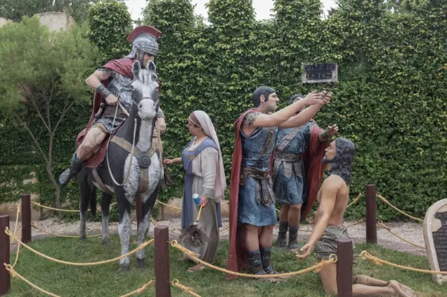 A statue showing Roman soldiers putting the crown of thorns on Jesus