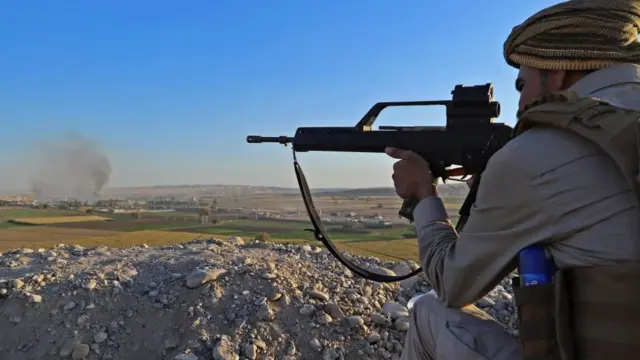 கிர்குக்கில் நெருங்கி வரும் இராக் படைகளைக் குறிவைக்கும் குர்து படையாள்.