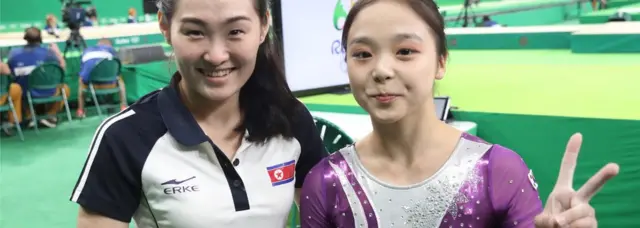 Artistic gymnasts Lee Eun-ju (R) of South Korea and Hong Un-jong of North Korea pose for a photo during the Rio 2016 Olympic Games Artistic Gymnastics events at the Rio Olympic Aren