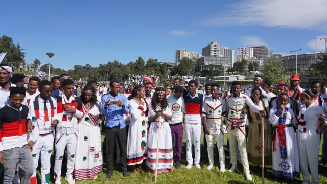 Men and women standing in a semi-circle