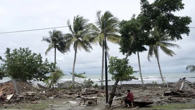 An Indonesian man sits down among the ruins of houses after a tsunami hit Sunda Strait in Anyer, Banten, Indonesia, 23 December 2018.