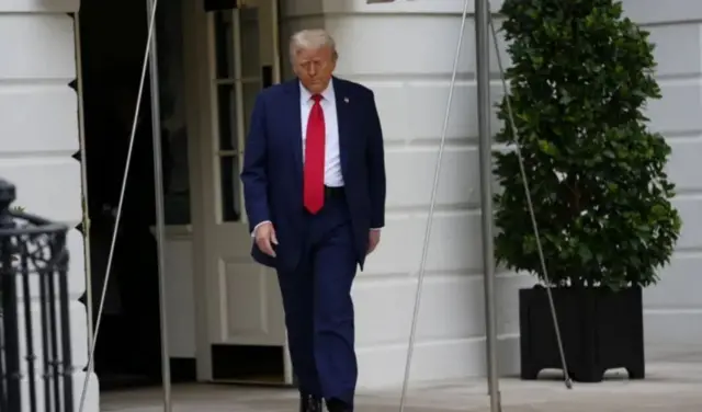US President Donald Trump wear one navy blue suit wit red tie. E go tok for Charlie Kirk memorial service later today.