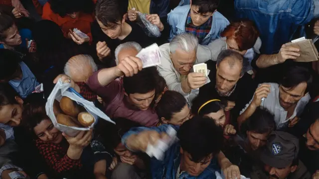 Gente luchando por coger comida durante el asedio a Sarajevo en la guerra de Bosnia.
