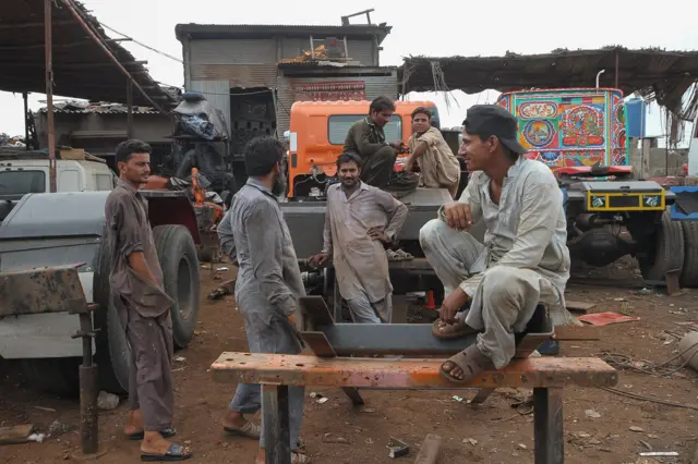 Varioci tokom pauze u jednoj od brojnih improvizovanih radionica, takozvanih ’ada’ na obodu Karačija, Pakistan. Čitav sektor prilagođavanja i ukrašavanja vozila vezuje se za ljude iz nižih društvenih slojeva a srednja klasa u Pakistanu uglavnom sa potcenjivanjem gleda na ovakav izraz nazivajući ga kičem i oličlenjem lošeg ukusa.