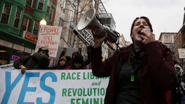 A demonstrator leads a chant before the inauguration of President-elect Donald Trump in Washington.