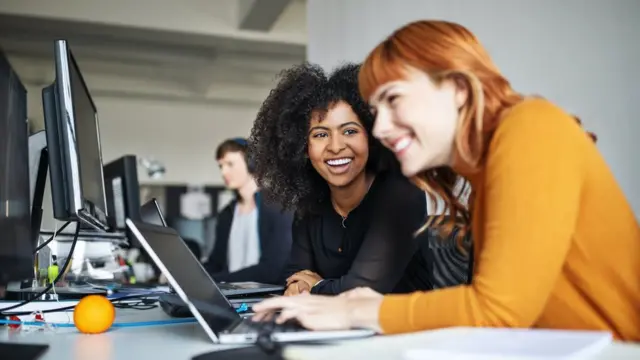 Two young women at work