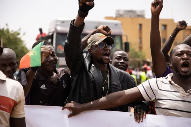 People take part in a march called by the opposition to protest against the security situation worsening and asking for a response to jihadist attacks, in Ouagadougou, on July 3, 2021.