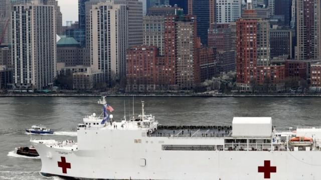 The USNS Comfort passes lower Manhattan in the New York Harbor during the outbreak of the coronavirus disease (COVID-19) in New York City, U.S., March 30, 2020