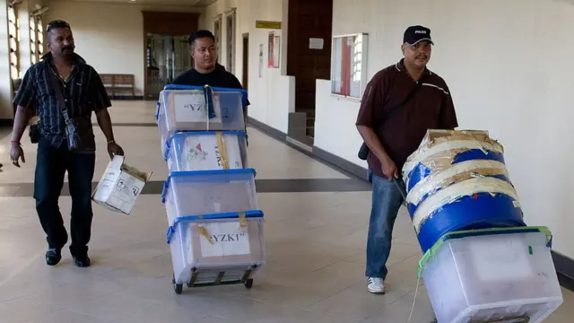 Funcionarios transportan pruebas del caso de narcotráfico en el que estuvieron involucrados los tres mexicanos.