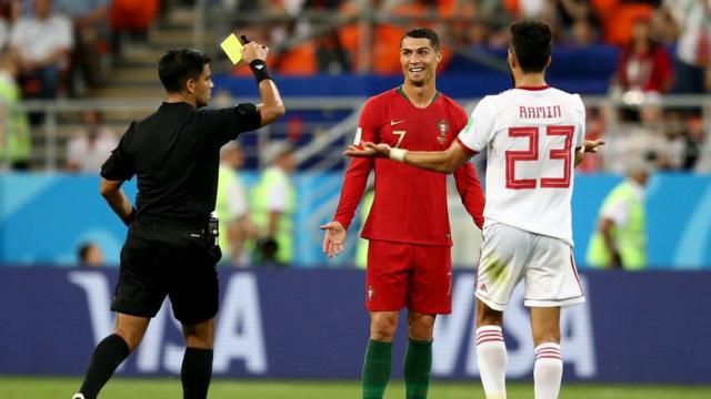 Cristiano Ronaldo of Portugal is shown a yellow card by referee Enrique Caceres during the 2018 FIFA World Cup Russia group B match between Iran and Portugal at Mordovia Arena on June 25, 2018 in Saransk, Russia.
