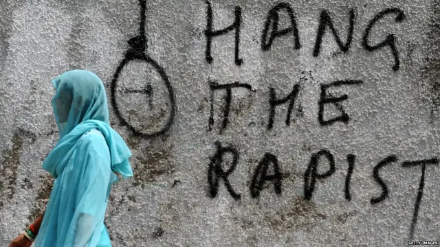 An Indian woman walks past graffiti against rape written on a wall in New Delhi on April 22, 2013. Indian police arrested a second man over the kidnap and rape of a five-year-old girl in New Delhi, but officers faced protests and a hail of criticism over their insensitive handling of the case.