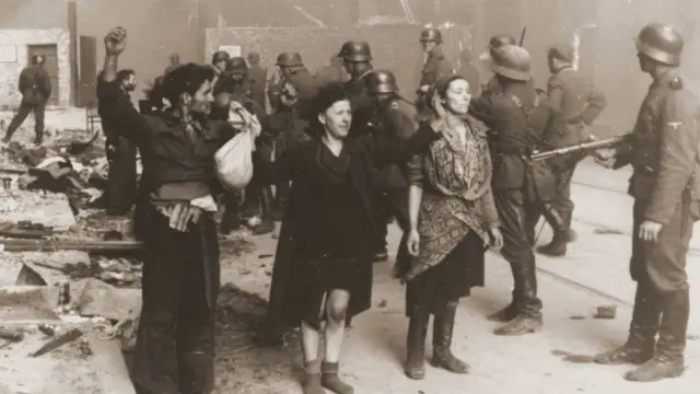 German Nazi SS troops guarding members of the Jewish resistance