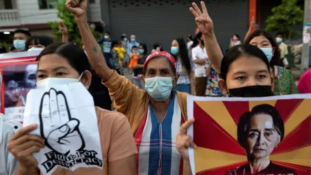 People with placards take part in a protest against the military coup outside the US embassy in Yangon, Myanmar, 16 February 2021