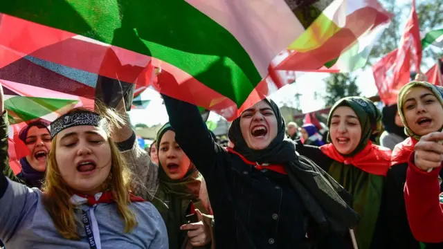Pro-Palestinian protesters chant slogans and wave Palestinian flags during a demonstration against the US president's recognition of Jerusalem as Israel's capital in Istanbul on December 8, 2017.