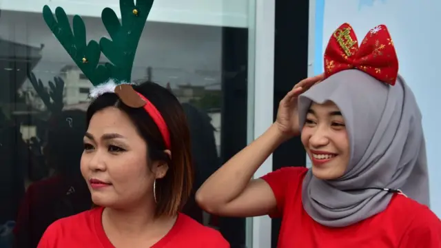 ٹھائی لینڈ کے جنوبی صوبے نارٹھیوت میں سپر مارکیٹ کے ملازمین نے کرسمس تھیم والی ٹوپیاں پہن رکھی ہیں۔