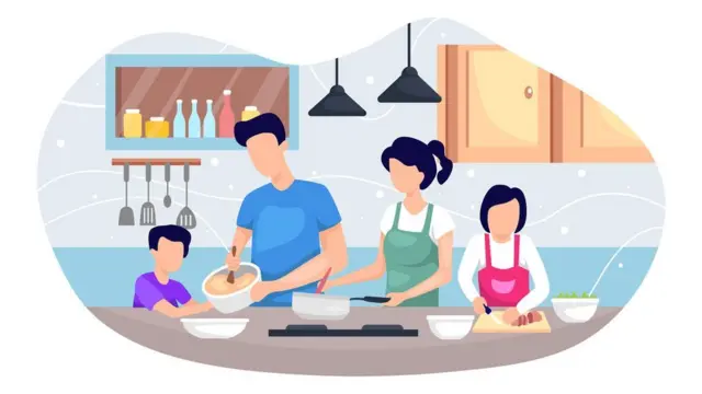 Family cooking a meal together with young children