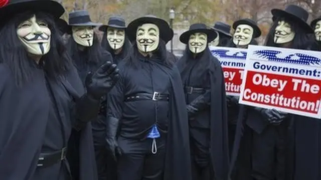 Protesters with 'We the People Foundation for Constitutional Education' dress in the costume of V in November 2006 in Washington, DC