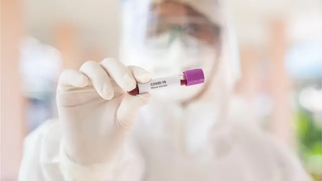 Scientist holds a sample tube
