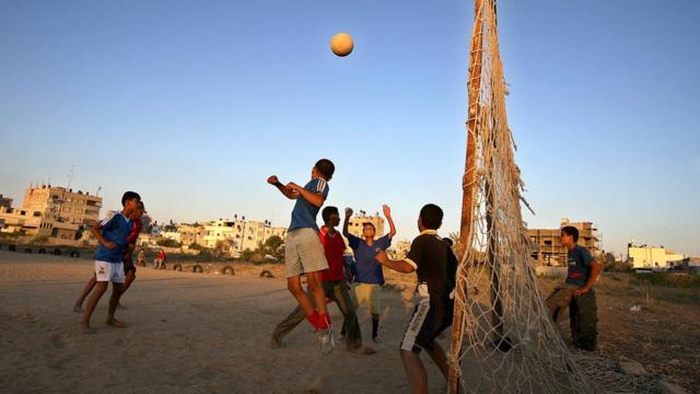 Palestinian boys play football in Gaza City 09 July 2006