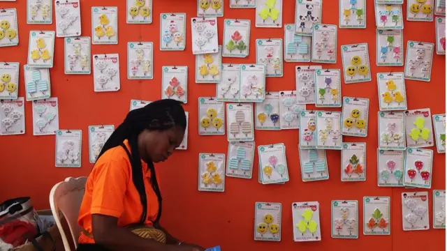 A woman selling children gift toys waits for buyers.