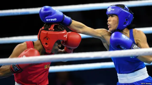 Mary Kom (in blue) fights Sri Lanka's Anusha Dilrukshi Koddithuwakku (in red) during their women's 45-48kg category semi-final boxing match during their 2018 Gold Coast
