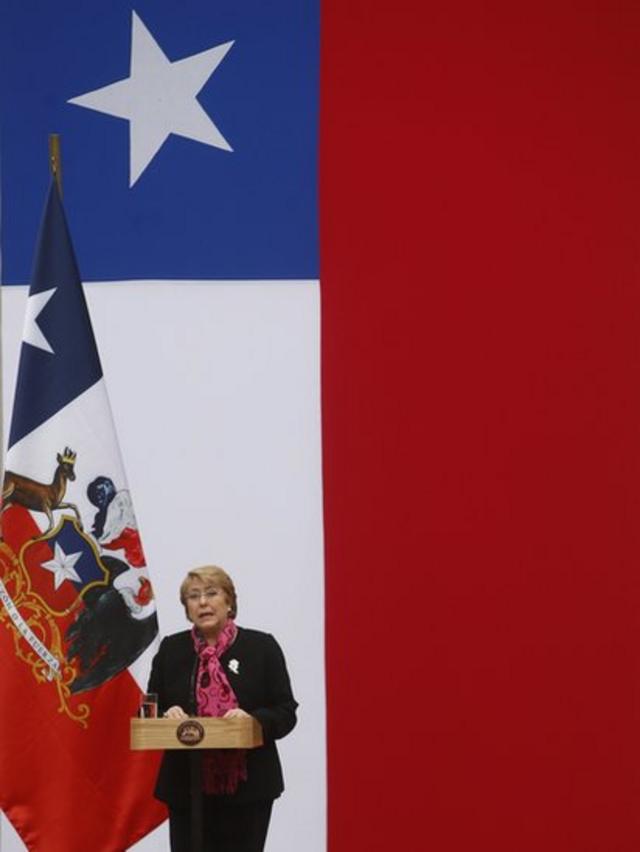 Michelle Bachelet con la bandera de Chile de fondo (crédito: EPA)