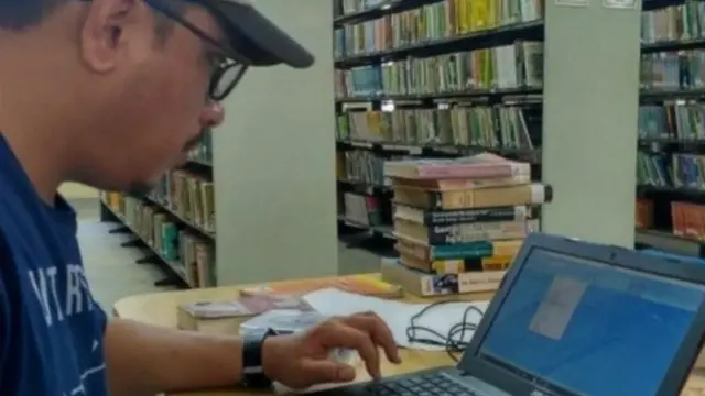 લાઇબ્રેરીમાં કામ કરતાં રમતના સમાજશાસ્ત્ર પર પીએચ. ડી. કરી રહેલા સનસમ યાઇફબા