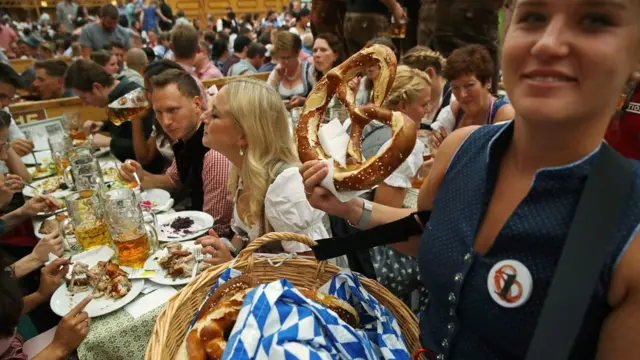 A waitress sells pretzels
