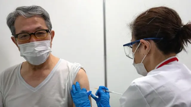 Elderly man receiving jab in Tokyo