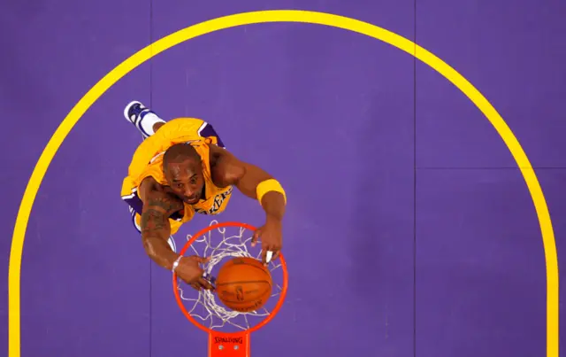 Kobe Bryant slam dunks against the Sacramento Kings during their NBA basketball game in Los Angeles in 2011.