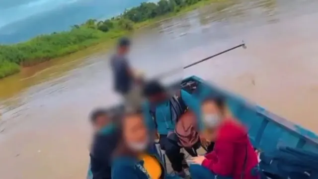 An image of crossing a river with a victim rescued by Thai authorities.