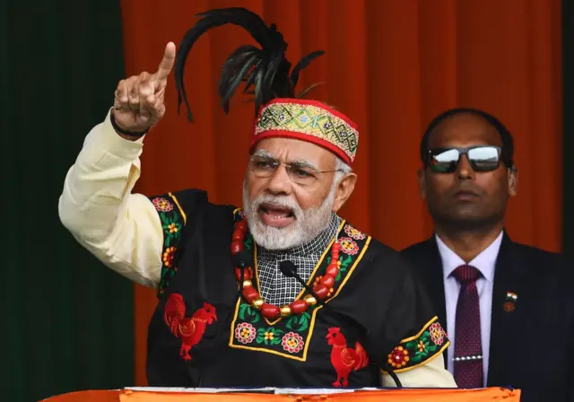 Indian Prime Minister Narendra Modi addresses a BJP rally dressed in traditional Khasi tribe attire and Garo tribe headgear, Shillong, December 2017