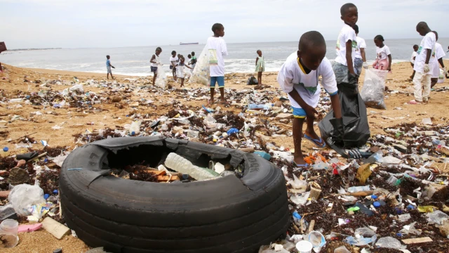 Children helping clean up a beach in Abidjan, Ivory Coast - Saturday 4 June 2022