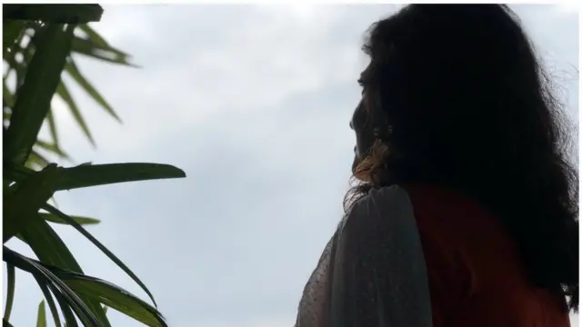 একজন নারী আকাশের দিকে তাকিয়ে রয়েছেন