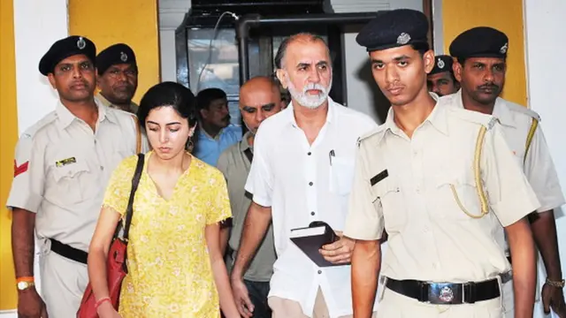 Tarun Tejpal (C) is escorted by police officials after a hearing at The High Court in Goa on March 4, 2014