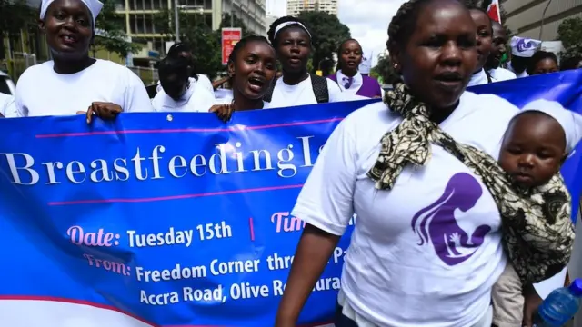 A group of protesters march towards a restaurant after a female client was allegedly thrown out for breastfeeding and not covering up in Nairobi's Central Business District on 15 May 2018.